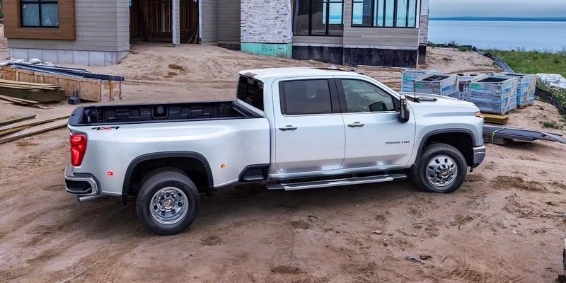 White Chevrolet Silverado in front of contruction site.
